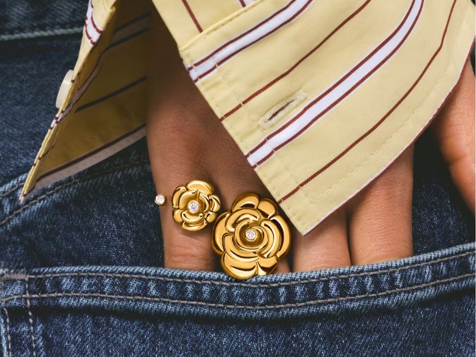 Złote pierścionki TOUS w kształcie kwiatów wystylizowane z dżinsami i koszulą