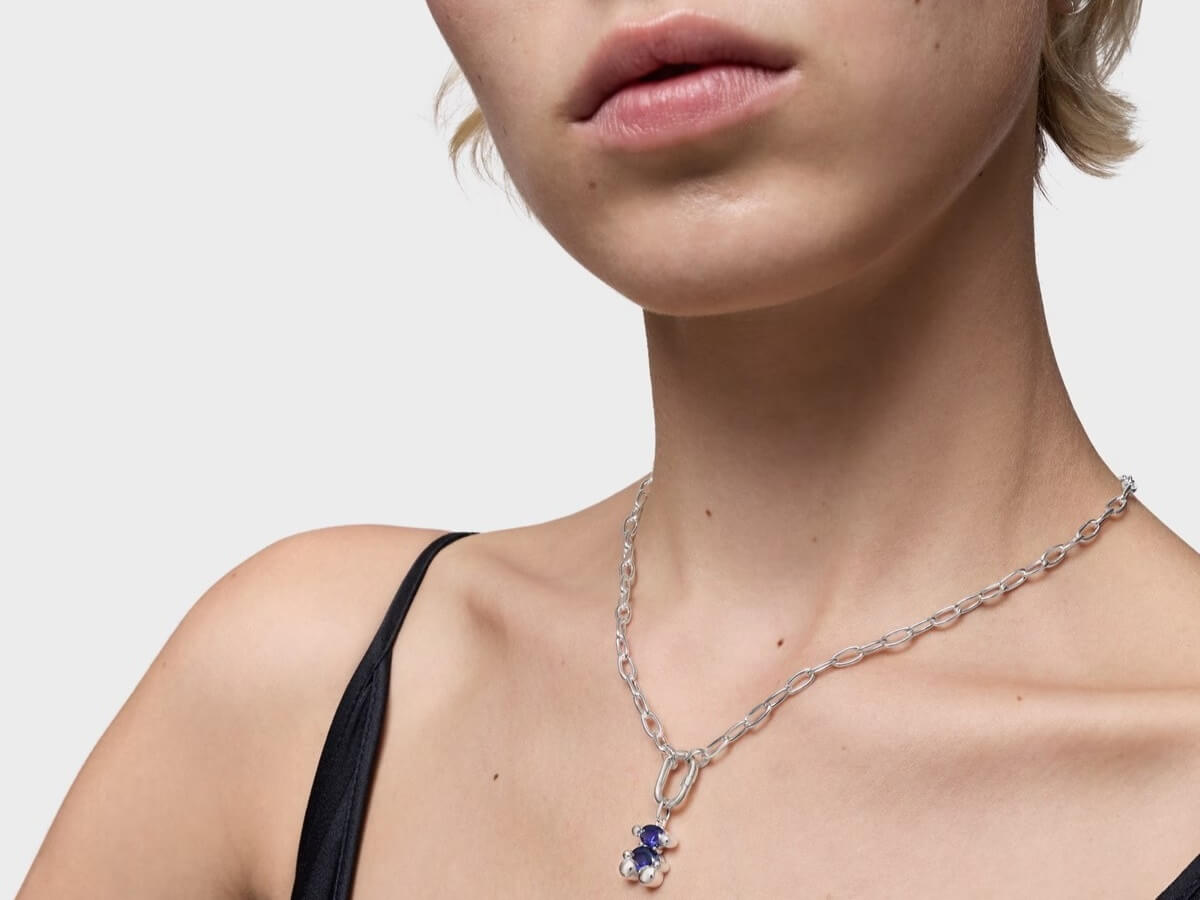 Kobieta ze srebrnym naszyjnikiem z szafirem na szyi